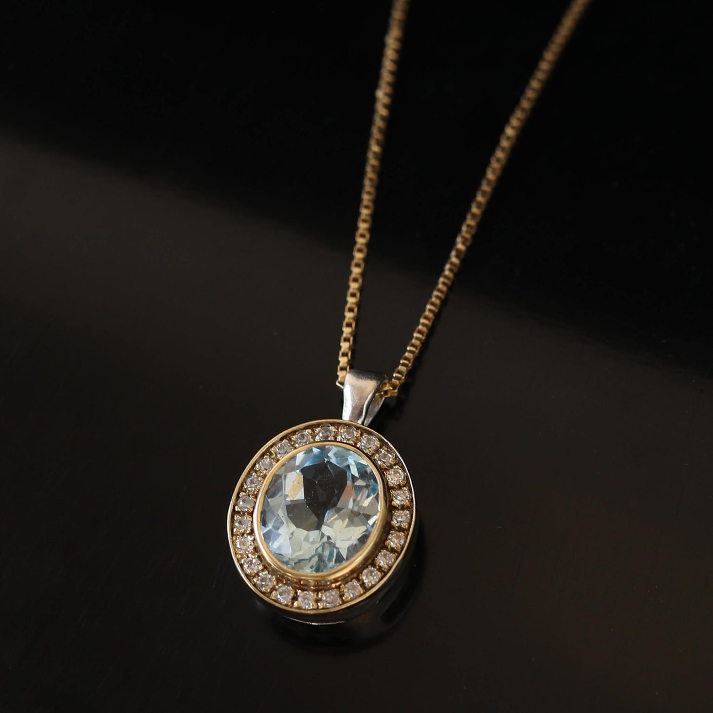 handmade silver with gold pendant with natural blue topaz stone