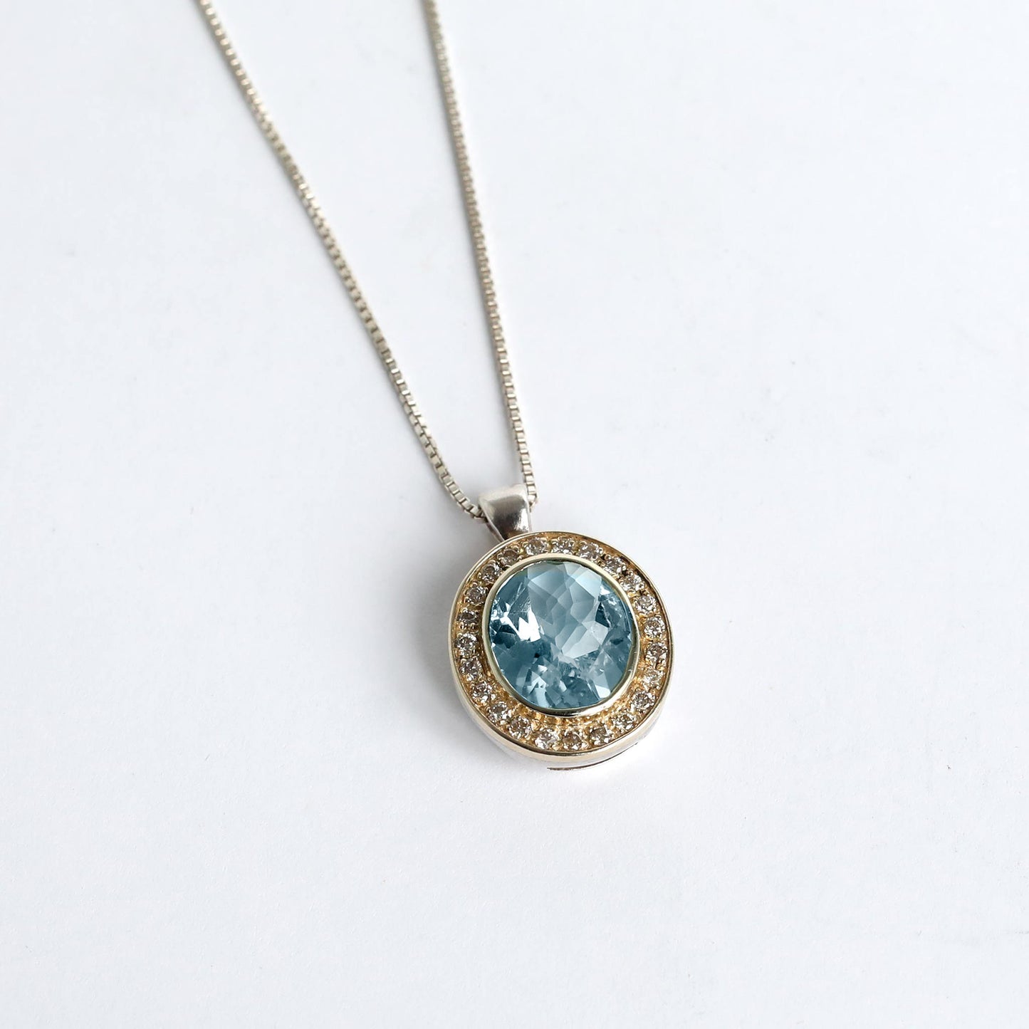 handmade silver with gold pendant with natural blue topaz stone